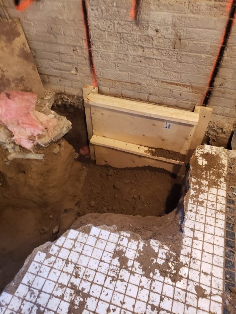 Underpinning excavation and formwork beneath a basement wall
